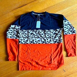 New with tags!Non smoking home.Tunic style sweater with small slits in hip area